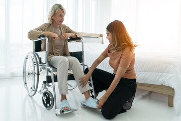 Grown-up daughter Take care mother sit wheelchair