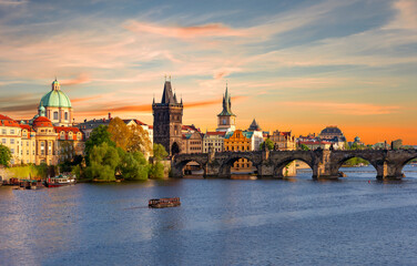 Obraz premium Classic Prague panorama with Old Town Bridge Tower and Charles bridge over Vltava river at sunset, Czech Republic