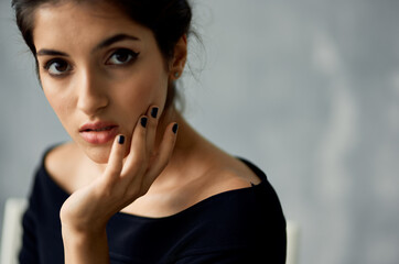 Fototapeta premium attractive woman in black dress decoration posing close-up