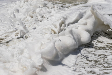 Arabian Ocean waves with foam of blue and turquoise color. Sea foam creating amazing shapes and patterns like glacier. Abstract Arabian Ocean blue water with white wave for background.