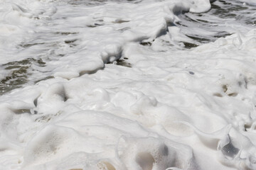 Arabian Ocean waves with foam of blue and turquoise color. Sea foam creating amazing shapes and patterns like glacier. Abstract Arabian Ocean blue water with white wave for background.