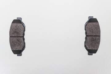 Two brake pads on the edges of the table, parts for car repair. A set of spare parts for servicing...