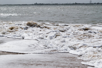 Arabian Ocean waves with foam of blue and turquoise color. Sea foam creating amazing shapes and patterns like glacier. Abstract Arabian Ocean blue water with white wave for background.