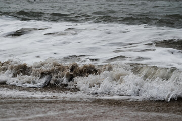 Arabian Ocean waves with foam of blue and turquoise color. Sea foam creating amazing shapes and patterns like glacier. Abstract Arabian Ocean blue water with white wave for background.