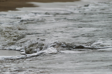 Arabian Ocean waves with foam of blue and turquoise color. Sea foam creating amazing shapes and patterns like glacier. Abstract Arabian Ocean blue water with white wave for background.