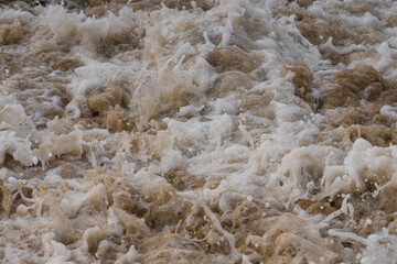 Arabian Ocean waves with foam of blue and turquoise color. Sea foam creating amazing shapes and patterns like glacier. Abstract Arabian Ocean blue water with white wave for background.
