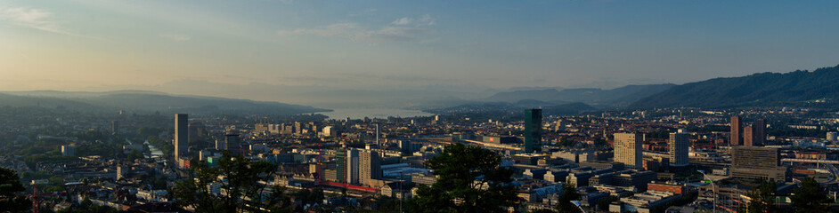 Large panorama of the city of Zurich in the morning with a blue sky from the Waid. 
