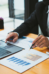 Businessman is deeply reviewing a financial report for a return on investment or investment risk...