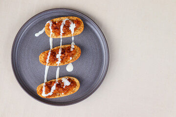 Cardamom crusts with cloudberry jam and custard on a gray plate
