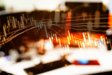 Abstract financial trading graphs and digital number of foreign exchange market trading on monitor. Background of gold and blue digital chart to represent stock market trend.	
