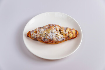 Delicious croissants and coffee cup on wooden plate. Freshly baked.