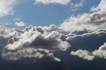 Dark and white clouds on a background of blue sky