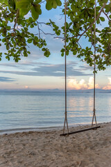 Nature in twilight period which including of sunrise over the sea and the nice beach. Summer beach with blue water and purple sky at the sunset.	
