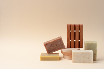 Soap on pastel beige background. Close up, copy space