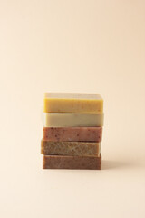 Soap on pastel beige background. Close up, copy space
