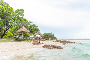 Beach sand, sea and blue sky with clouds. Nature in twilight period which including of sunrise over the sea and the nice beach. Summer beach with blue water and purple sky at the sunset.	