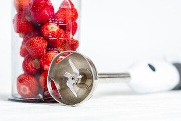 The process of making strawberry mousse, cocktail. Strawberry puree, smoothie in a blender