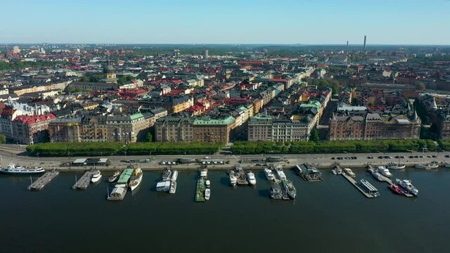 Stockholm city Skyline of &Ouml;stermalm. Densely populated residential area in city center with colorful buildings and rooftops. Pan aerial shot.