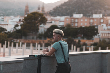 a gay boy parks his scooter to look at the horizon to think about his problems.
anxiety.
lgtbi