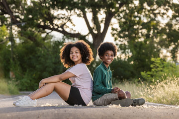 Two afro children curly hair style having fun with holiday at sunset time.Friendship and youth girlfriends vacation lifestyle concept.