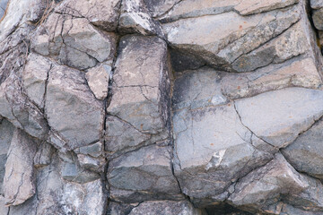 
texture of gray stone with cracks. Texture mountain close up. Background for wallpaper on the phone, computer with the texture of a stone mountain