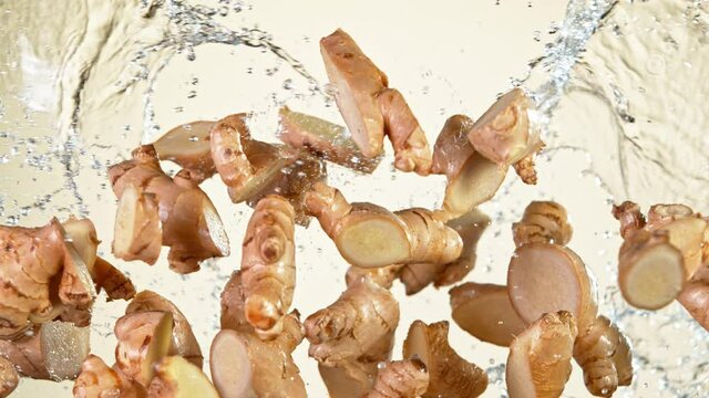 Super Slow Motion Shot of Flying Ginger Cuts and Water Side Splash at 1000 fps.