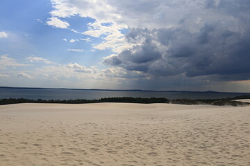 rainy clouds over sand dunes in park