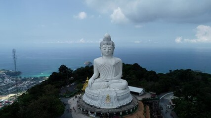 Aerial view Drone camera video of White Marble Big Buddha Statue Temple on highest mountain Beautiful landmark in Phuket Thailand Original File from Drone Phantom 4 pro v2.0 - Powered by Adobe