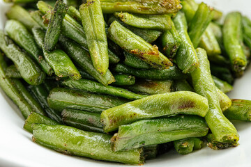 Closeup on portion of fried green string beans garnish