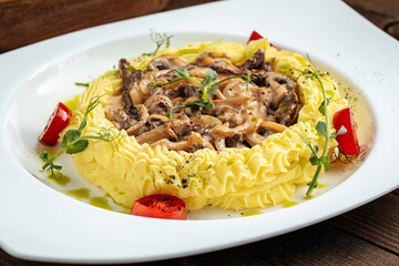 Stroganov veal with mashed potatoes and mushrooms in cream sauce