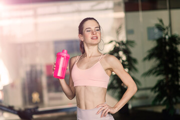 Athletic girl in sportswear performs exercises with barbell, dumbbells. Fitness, healthy lifestyle