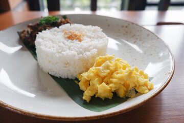 menu for food Madurese black herbs duck. This menu is a typical black jamu duck food from Madura, East Java with the addition of white rice and a few sprinkles of vegetables 