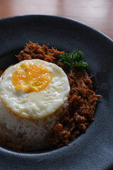 Menu of bluron duck on the wooden table. bluron duck is slow-cooked pulled duck, marinated herbs, steamed rice, sunny side-up eggs