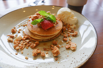 Vanilla crumb pencakes with ice cream and topping strawberry