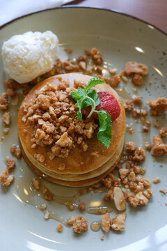 Close up Vanilla crumb pencakes with ice cream and topping strawberry. Top view