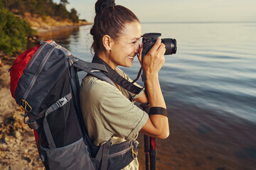 Tourist taking photographs of nature on her camera