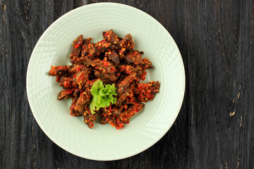 Top View Balado Paru, Traditional Indonesian Food Made from Beef Lungs. Cooked with a Lot of Chilli, Garlic, Shallots, and Lime Leaf. Delicious with Spicy Taste.
