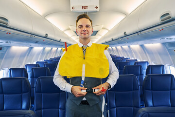 Steward securing straps of a life vest around his waist