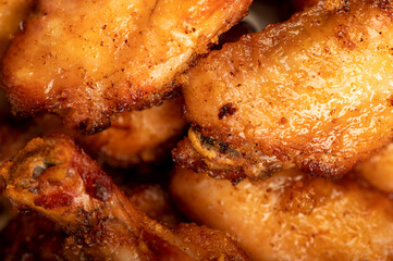 Fried chicken wings on a plate, close-up, selective focus.