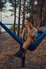 Traveller sitting in hammock and looking to the side