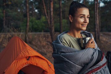 Female in woods with cozy blanket on her shoulders