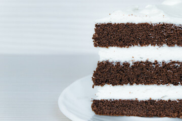 The chocolate sponge cake with butter cream is located on the right. Close-up