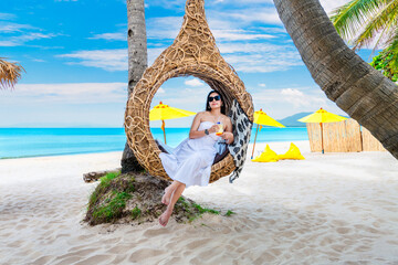 Summer lifestyle traveler woman relaxing on straw nests joy nature view landscape vacation luxury...