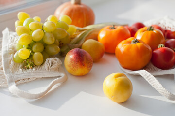 still life with vegetables and fruits and reusable net shopping bag for  groceries