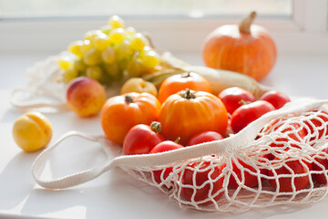 still life with vegetables and fruits and reusable net shopping bag for  groceries