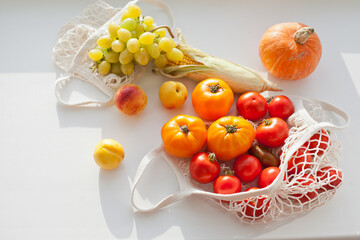 still life with vegetables and fruits and reusable net shopping bag for  groceries