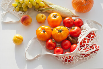 still life with vegetables and fruits and reusable net shopping bag for  groceries