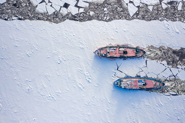 Icebreakers on river crushes the ice in cold winter.
