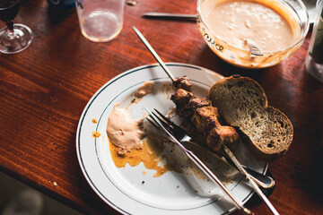 Fine meat prepared on the charcoal grill is on the plate - the meal has begun