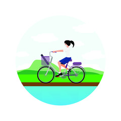 Naklejka premium A girl riding a bicycle in the countryside